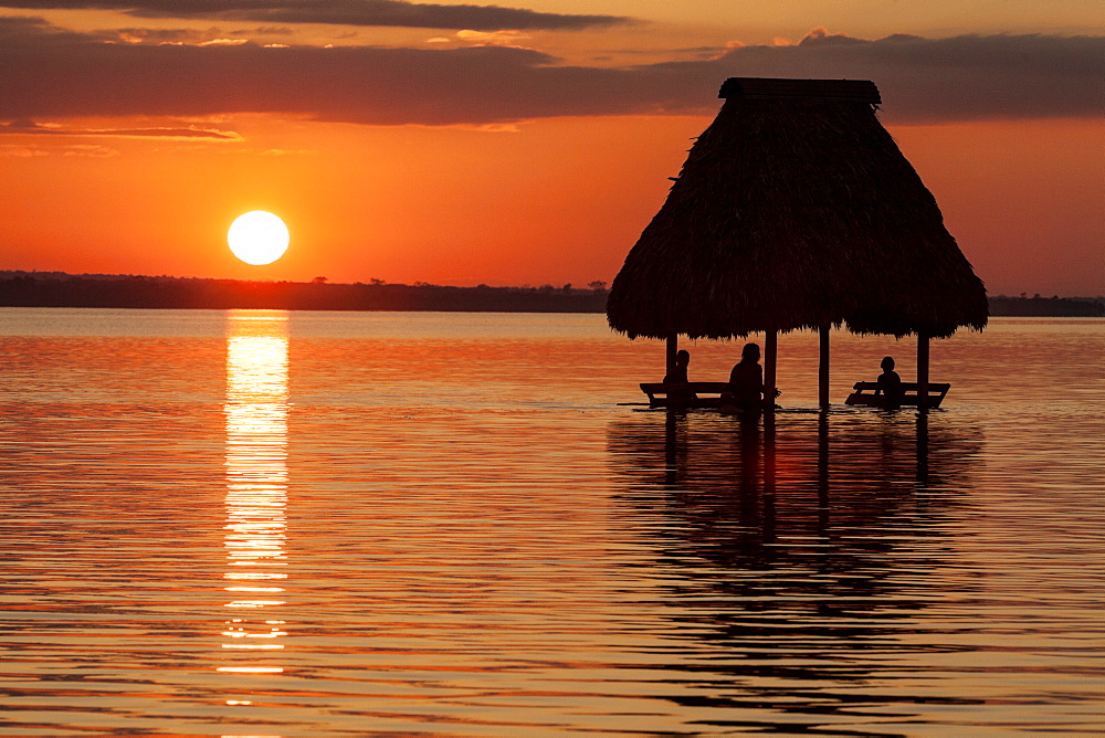 People relaxing at sunset, Lago Peten Itza, El Remate, Guatemala, Central America