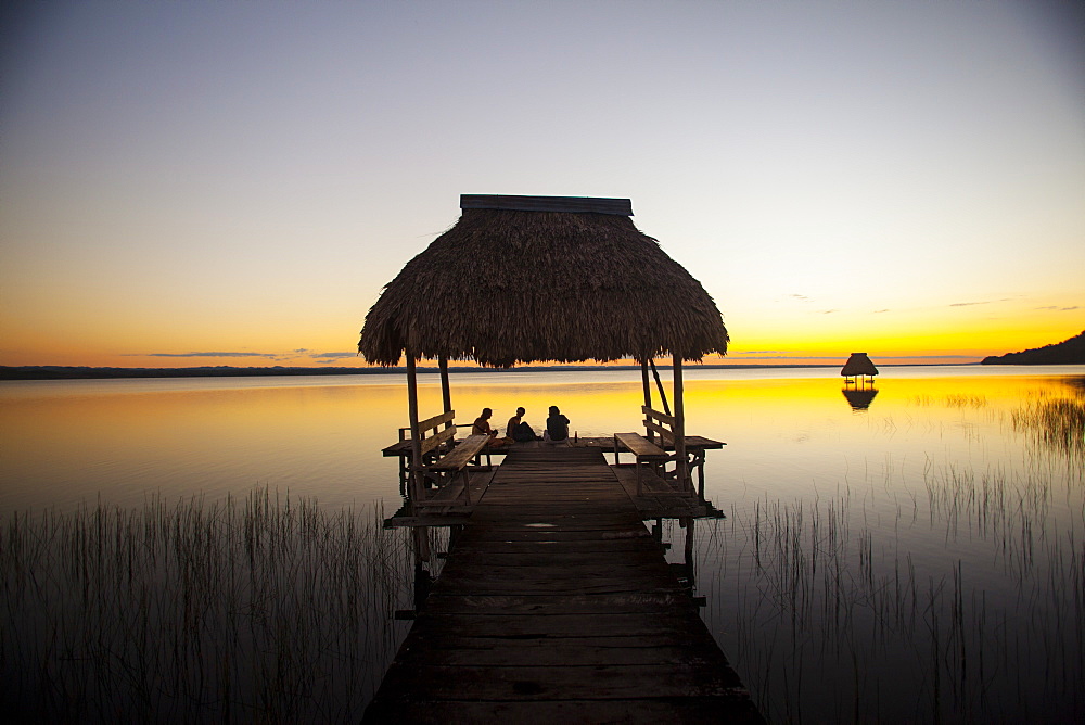 People relaxing at sunset, Lago Peten Itza, El Remate, Guatemala, Central America