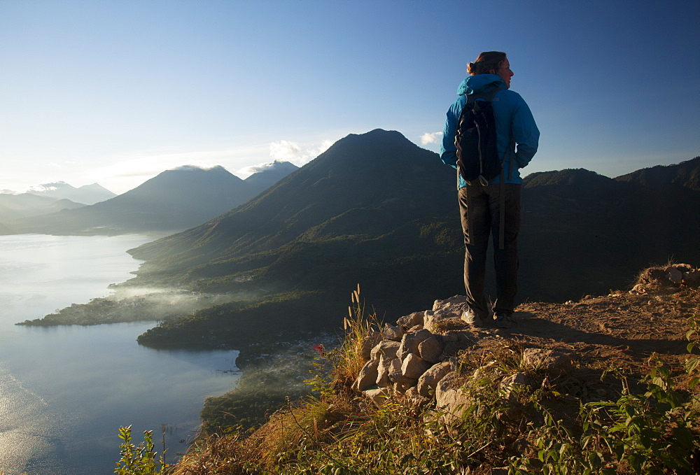 Woman enjoying the view from the Indian Nose lookout, Lago Atitlan, Guatemala, Central America