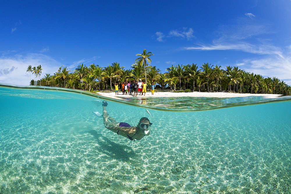 Snorkeling off palm-lined Island, Fadol, Kai Islands, Moluccas, Indonesia