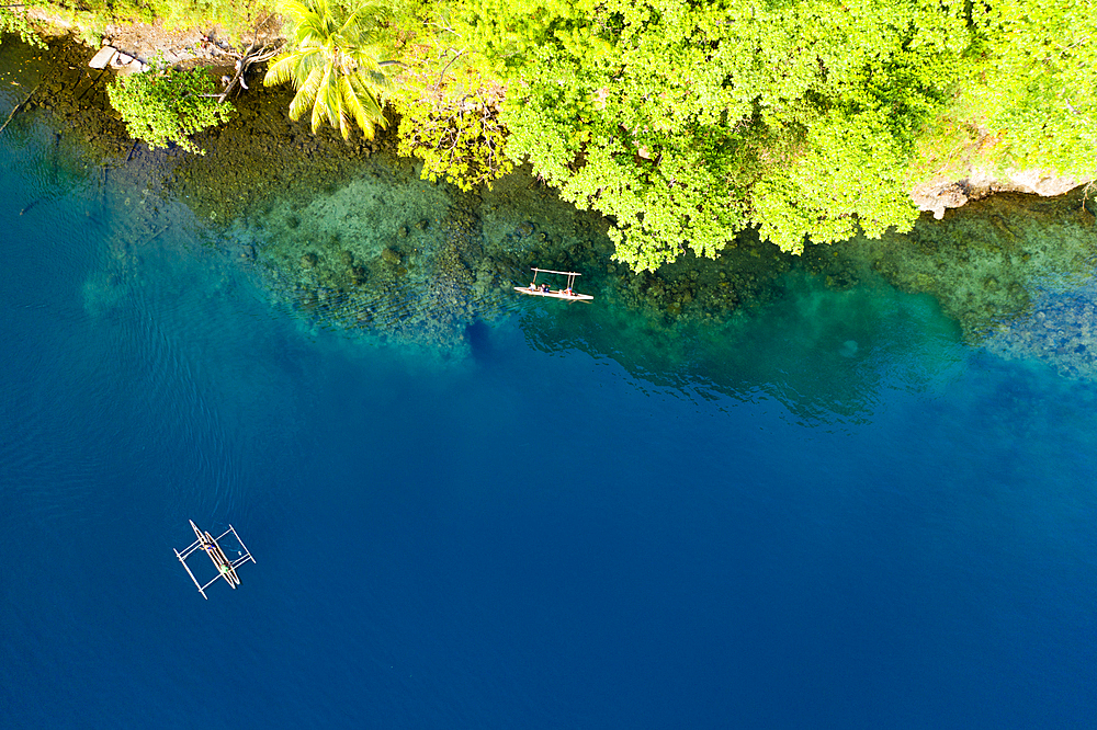 Residents in Outrigger Canoe, Tufi, Cape Nelson, Papua New Guinea