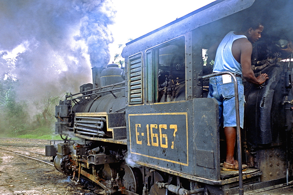 An old American steam engine is still used at a Cuban sugar mill on a plantation in central Cuba, Cuba