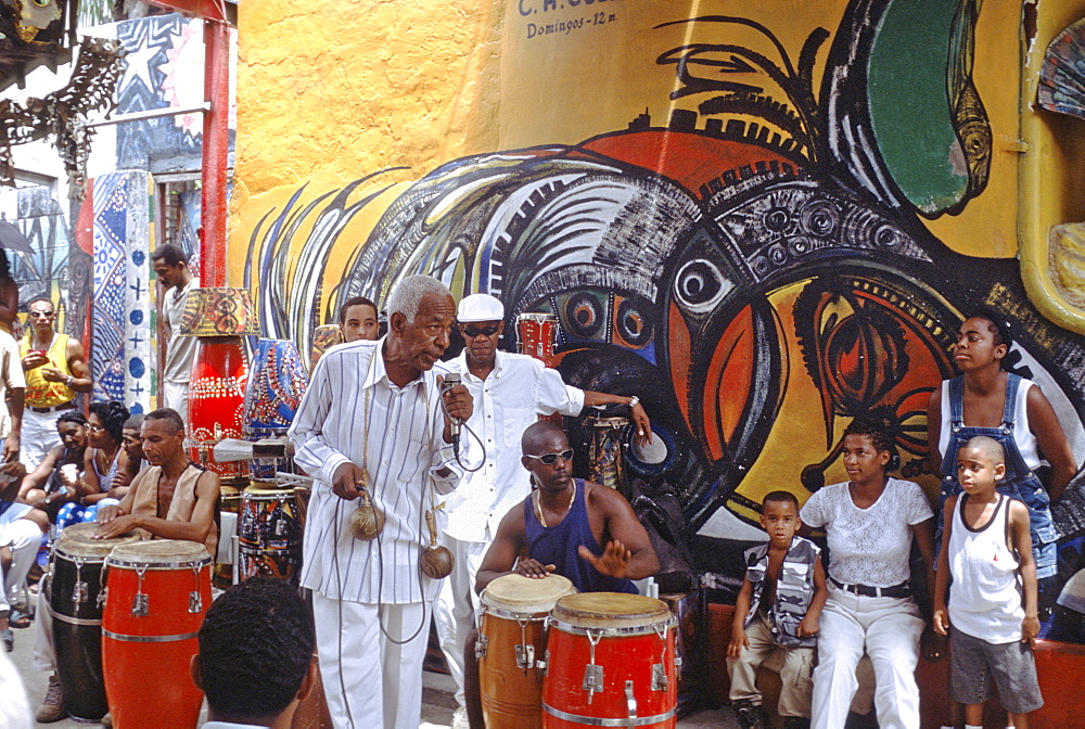 A rumba singer entertaining passersby on the Callejon de Hammel, a street with colorful murals in the Cayo Hueso area of Havana, Cuba