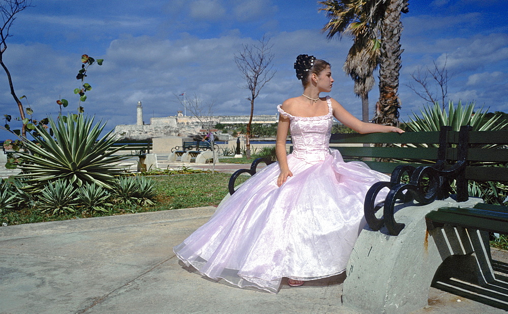 A Quinceanera a young girl having her portrait taken as part of celebrating her fifteenth (Quince Anos) birthday, Havana, Cuba