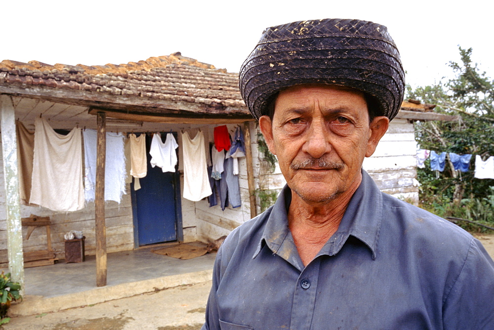 A cafetero or coffee farm worker in front of his home in the mountains of Sancti Espiritus Province in central Cuba, Cuba