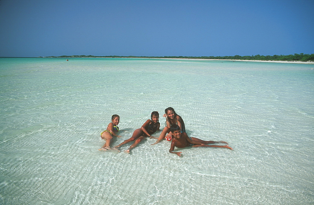 Cayo Coco young children on sandbar at Playa Flamingo Beach, Cuba