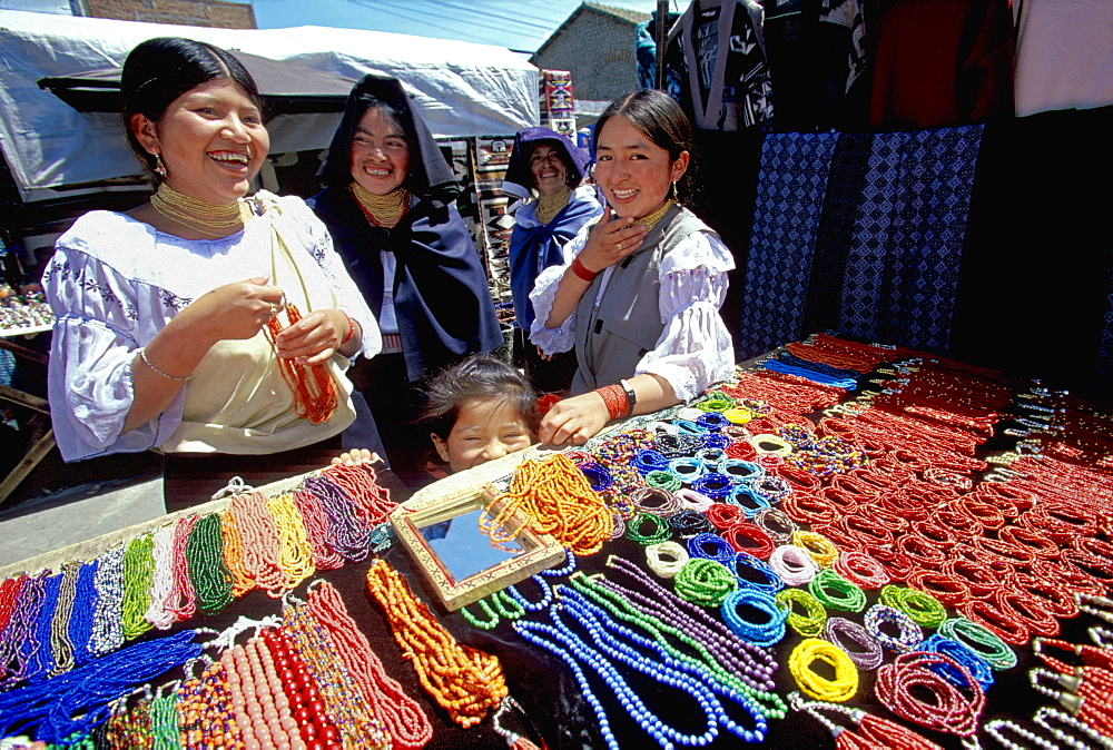 Otavalo, north of Quito is one of Latin Am's most famous markets for textiles, crafts and produce Otavalo women buying necklaces, Quito, Ecuador