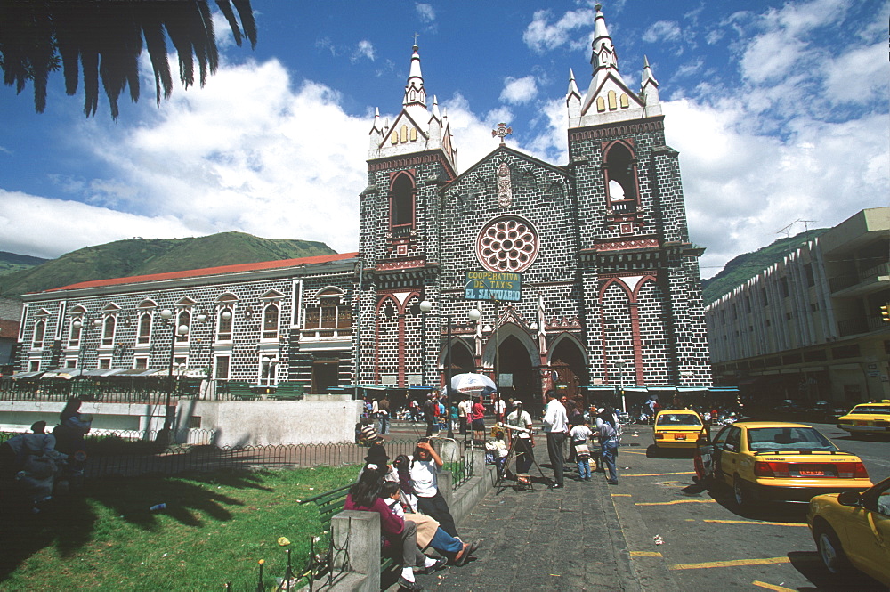 Banos resort and famous hot springs in semitropical area Basilica of Senora de Agua Santa, facade of church on main plaza, Highlands, Ecuador