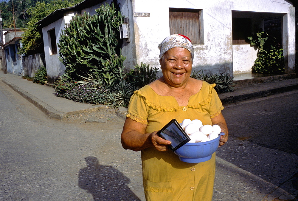 A women selling fresh eggs on the street in the town of Baracoa in eastern Cuba, Cuba