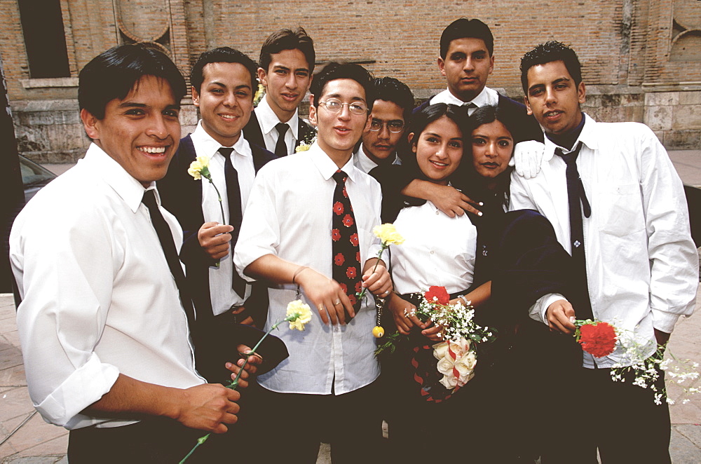 Cuenca World Heritage City & Ecuador's third largest city, highschool students with flowers going to Cathedral for special mass for students, Highlands, Ecuador