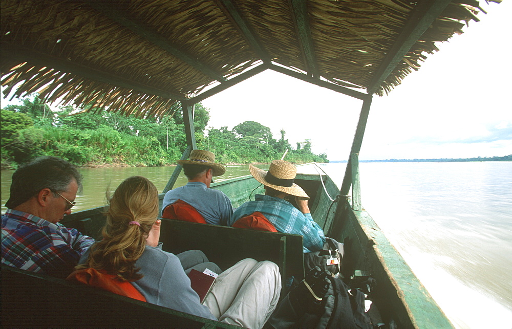 Amazon Basin, Napo River (tributary) La Selva Jungle Lodge, visitors traveling to lodge by motorized dugout canoe, Amazon, Ecuador