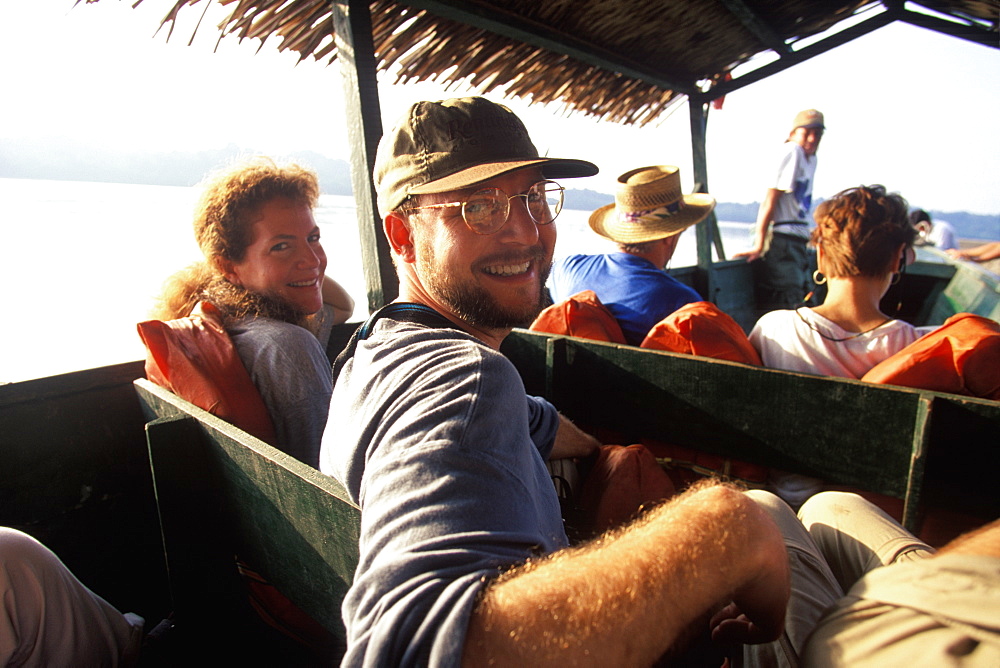 Amazon Basin, Napo River (tributary) La Selva Jungle Lodge, visitors traveling to lodge by motorized dugout canoe, Amazon, Ecuador