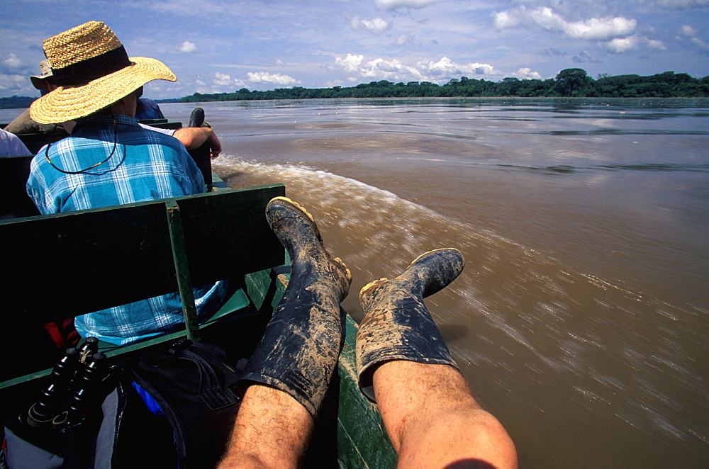 Amazon Basin, Napo River (tributary) La Selva Jungle Lodge, naturalists in dugout canoe on the Napo passing through rainforest, Amazon, Ecuador