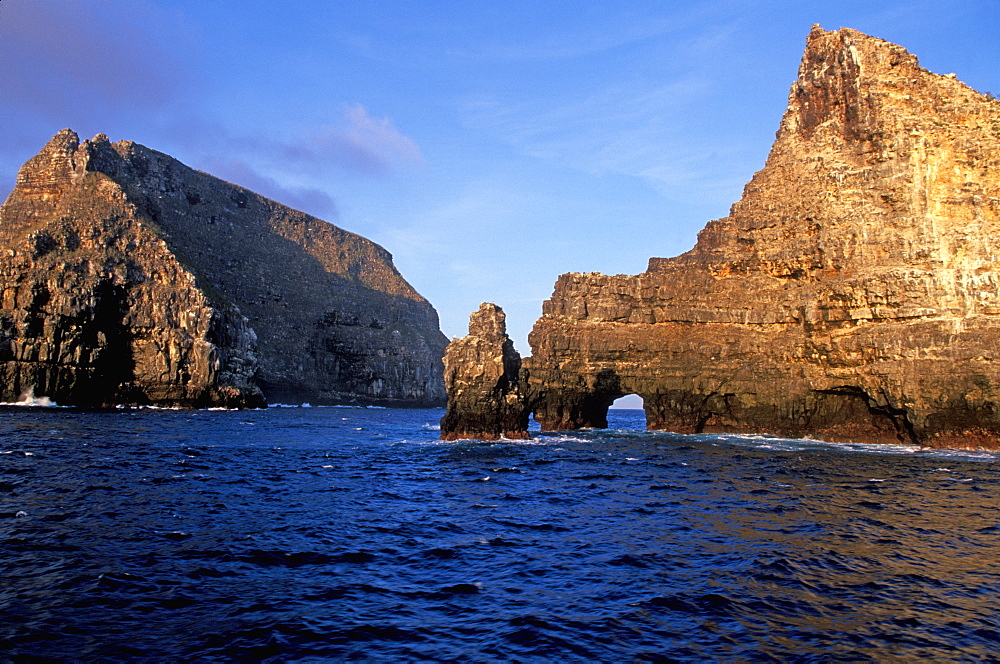 Sea arch and steep, rugged, volcanic cliffs surround Wolf Island one of the newest and most northerly of the Galapagos Islands, Galapagos Islands, Ecuador