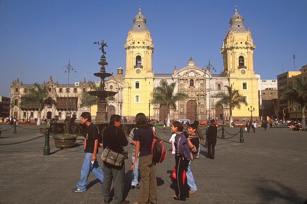 Students gathering in the Plaza de Armas with the Cathedral and the Archbishop's Palace beyond, Colonial Architecture, Lima, Peru