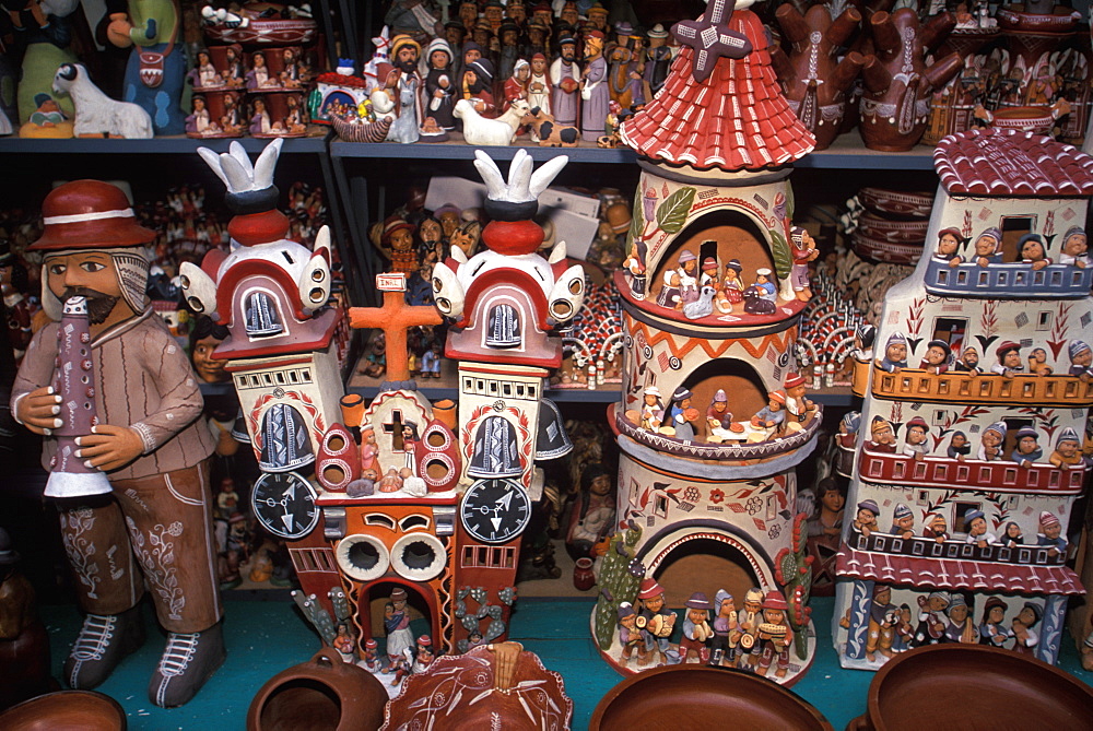 Ceramic figures and churches are examples of the varied folkart to be found in the handicraft market in Miraflores, Lima, Peru