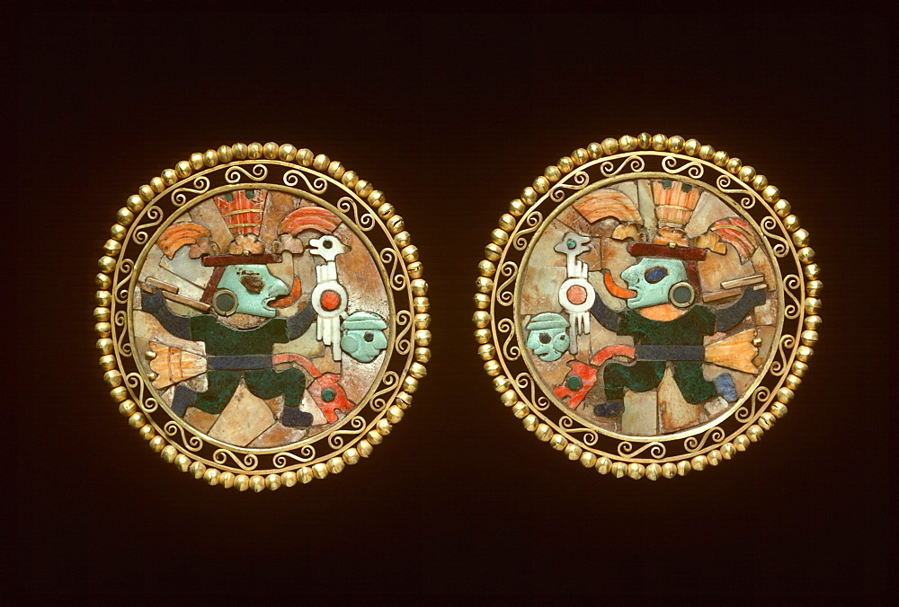 Precolumbian Gold Chimu Culture, 1000-1400AD ear ornaments of gold, lapiz and turquoise shows warrior with victim's head Museo del Oro, Lima, Peru