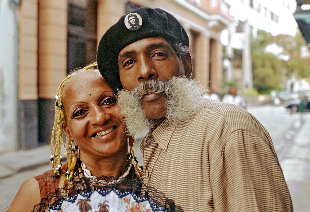 A flamboyant Cuban couple (professional dance duo called Danzamor) posing together on a street in Habana Vieja, Havana, Cuba