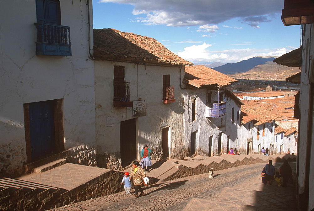 Traditional homes, constructed of adobe and tile, lining the streets that climb the very steep hills surrounding Cuzco, Highlands, Peru