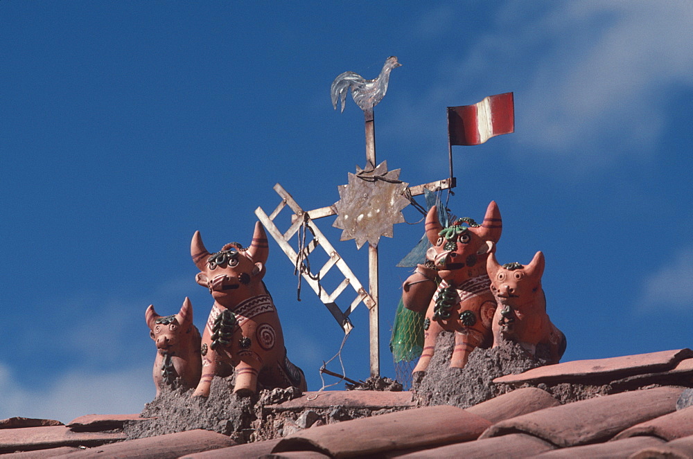 Folk art particular to the Cuzco area are the small bulls or 'toritos' placed on roofs of new homes to bring good luck to inhabitants, Cuzco, Highlands, Peru