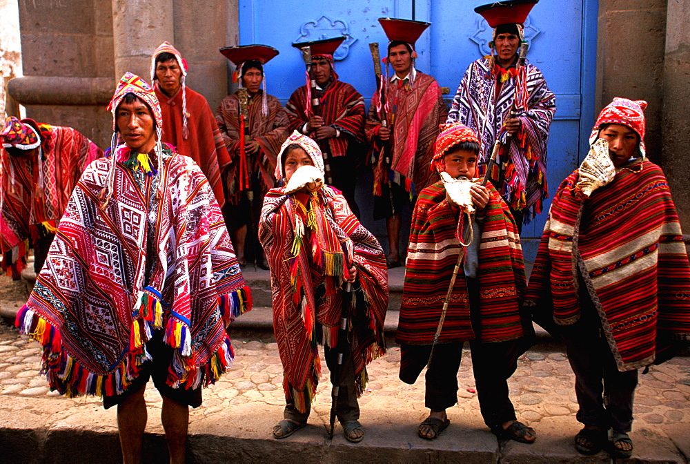 Pisac, village in Sacred Valley near Cuzco and one of world's most colorful markets village elders and boys blowing shell horns, Highlands, Peru