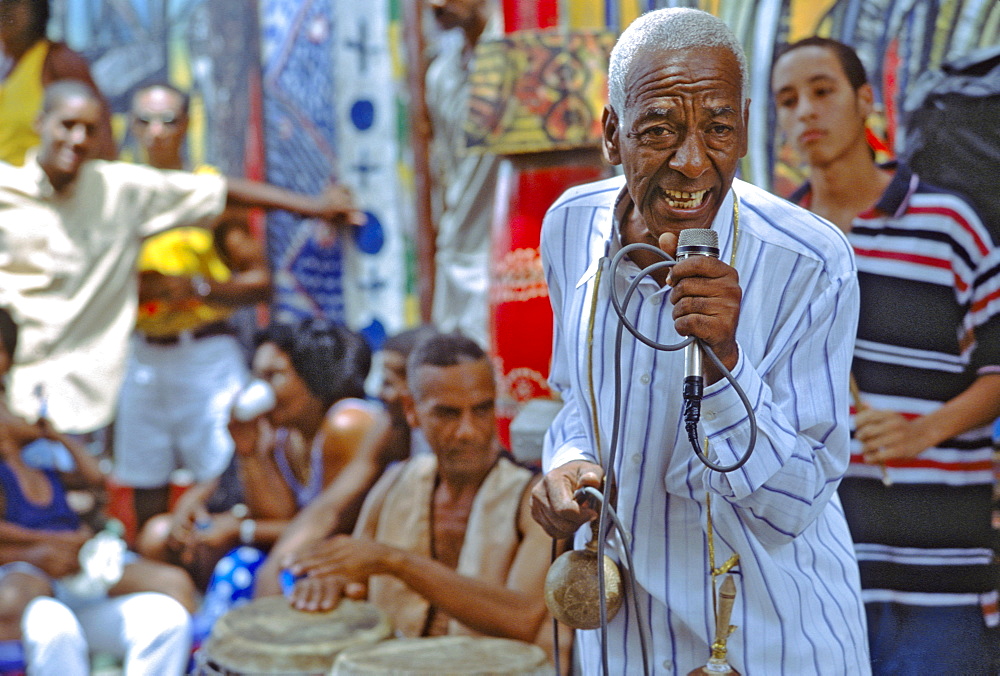 A rumba singer entertaining passersby on the Callejon de Hammel, a street with colorful murals in the Cayo Hueso area of Havana, Cuba