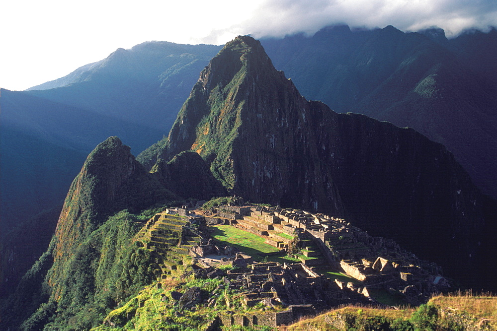 Machu Picchu view of the ancient city with Huayna Picchu Peak above the Rio Urubamba in the Vilcabamba Mountains, Highlands, Peru