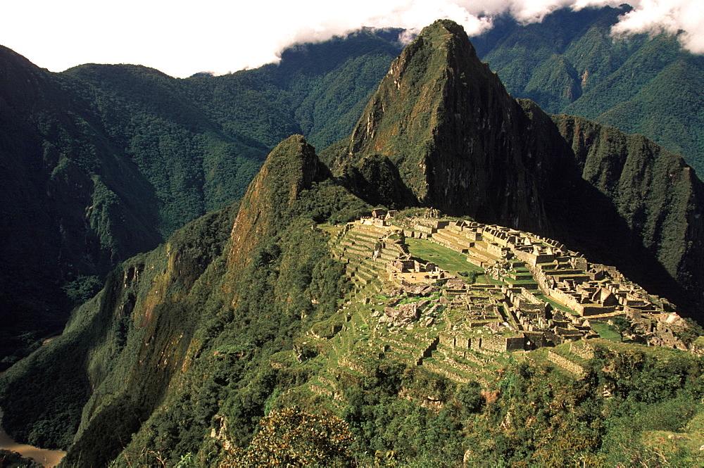 Machu Picchu view of the ancient city with Huayna Picchu Peak above the Rio Urubamba in the Vilcabamba Mountains, Highlands, Peru