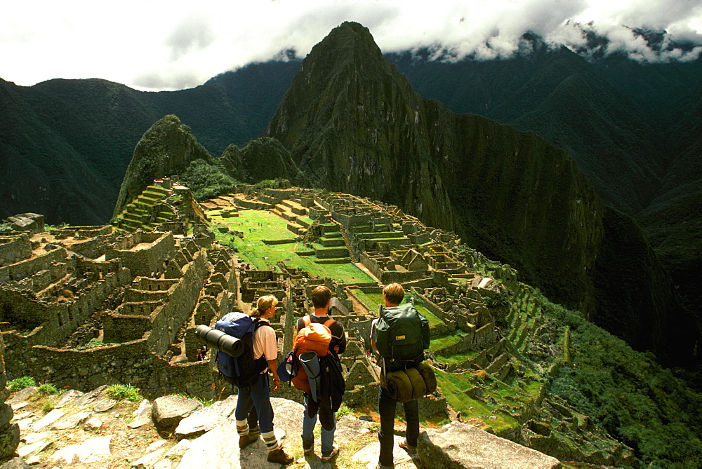 Machu Picchu view of the ancient city with Huayna Picchu Peak above the Rio Urubamba hikers viewing the site from Inca trail, Highlands, Peru