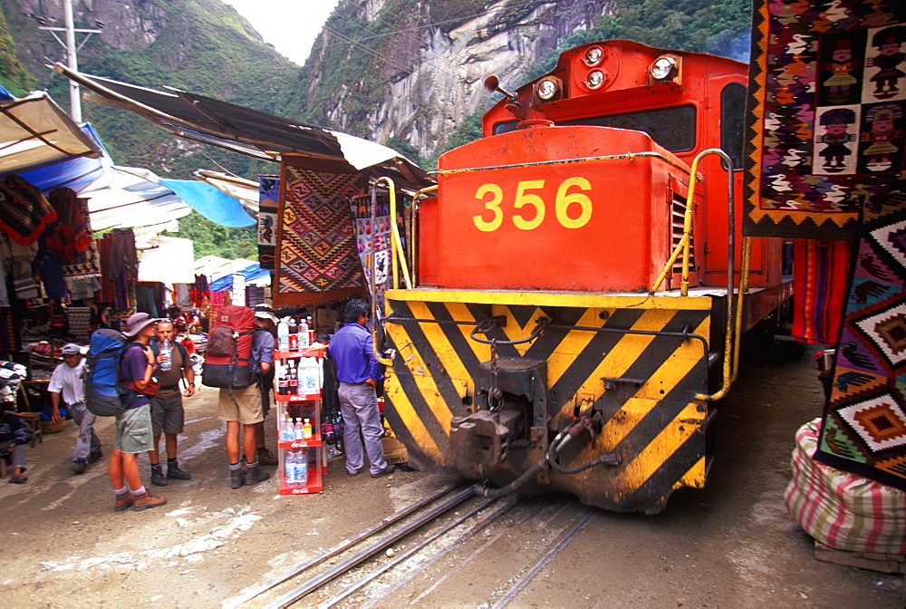 Machu Picchu the train from Cuzco arrives in Aguas Calientes the town and station below site train passes vendors on main street, Highlands, Peru