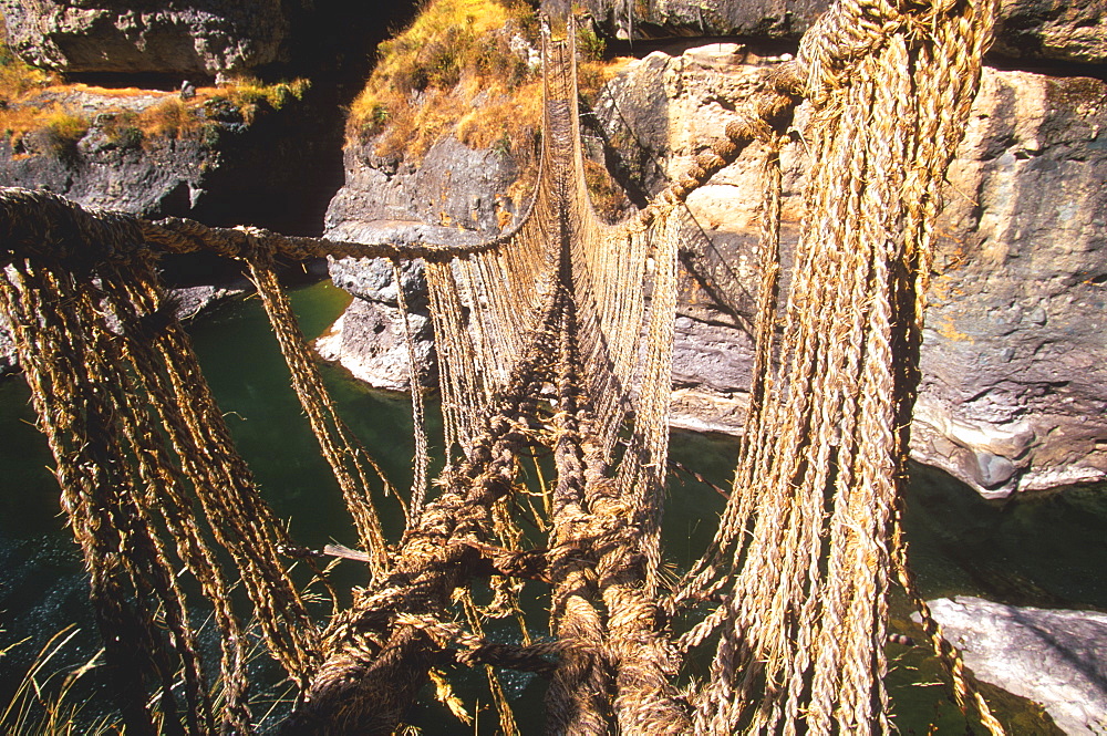 Famous Incan grass-rope suspension bridge across Apurimac River rebuilt annually since Incan period and only one still in existence, Inca Road, Altiplano, Peru