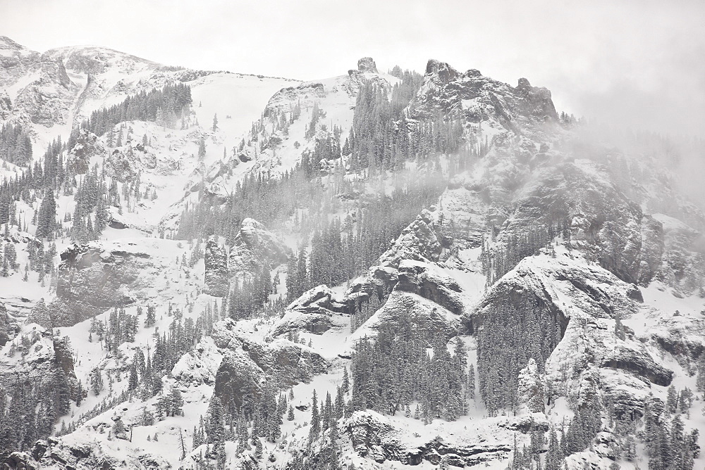 Snow-covered mountains covered with fog, Ouray County, Colorado, United States of America, North America