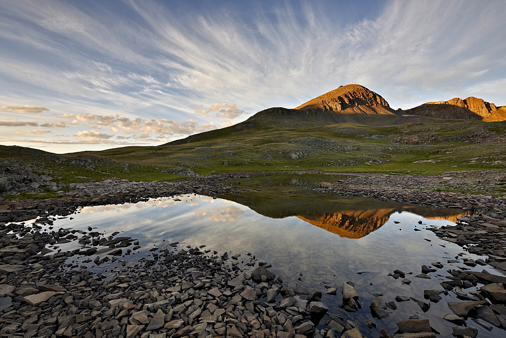 Clouds at dawn reflected in an Alpine tarn, San Juan National Forest, Colorado, United States of America, North America