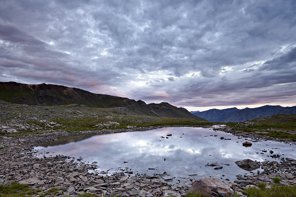 Clouds reflected in a tarn at Stony Pass, San Juan National Forest, Colorado, United States of America, North America