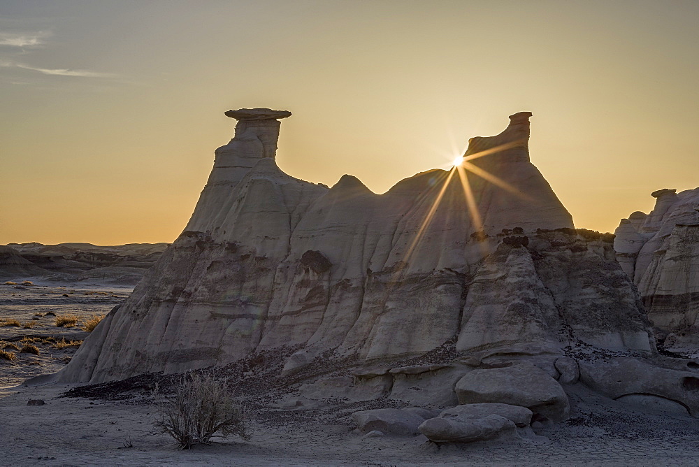 Sunburst behind a rock formation, Bisti Wilderness, New Mexico, United States of America, North America