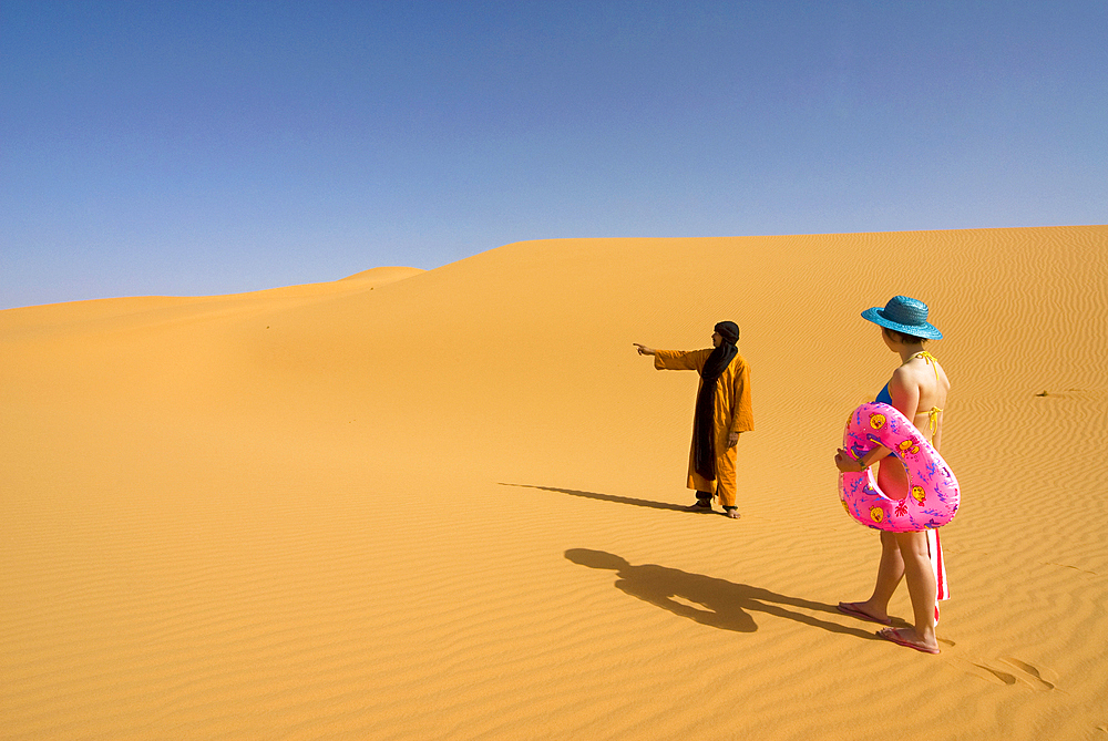 Girl looking for the sea in the Sahara desert, Erg Awbari, Sahara desert, Fezzan, Libya, North Africa, Africa