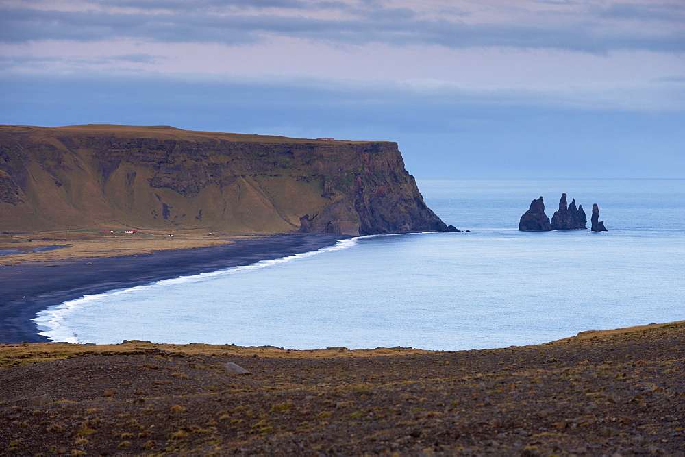 Black sand beach, rock formation and Reynisdrangar sea stacks in the distance, from Dyrholaey near Vik, Iceland, Polar Regions