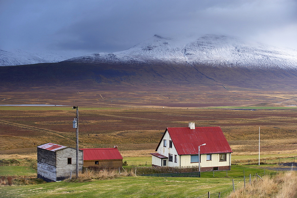 Farm and landscape in Vatsnes Peninsula, with snow-covered mountains in October, north coast of Iceland, Iceland, Polar Regions