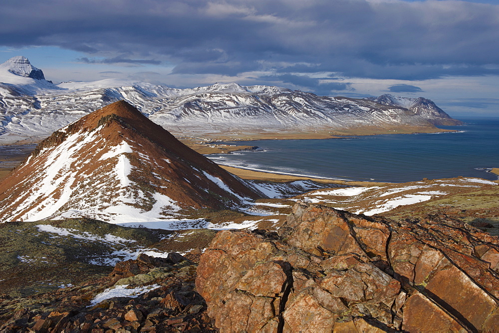 View over Fjardara valley, Borgarfjorur Eystri fjord, Bakkagerdi village and Mount Dyrfjoll (Door Mountain), 1136m, in the distance, from east side of the fjord, East Fjords area, Iceland, Polar Regions