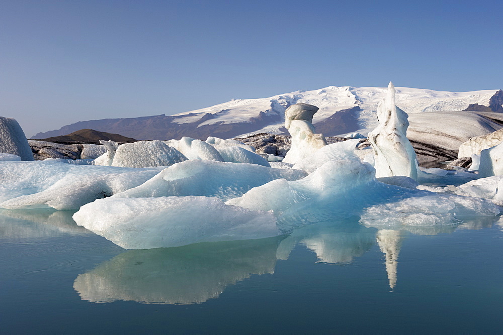 Icebergs in Jokulsarlon glacial lagoon, Oraefajokull glacier in the distance, East Iceland, Iceland, Polar Regions