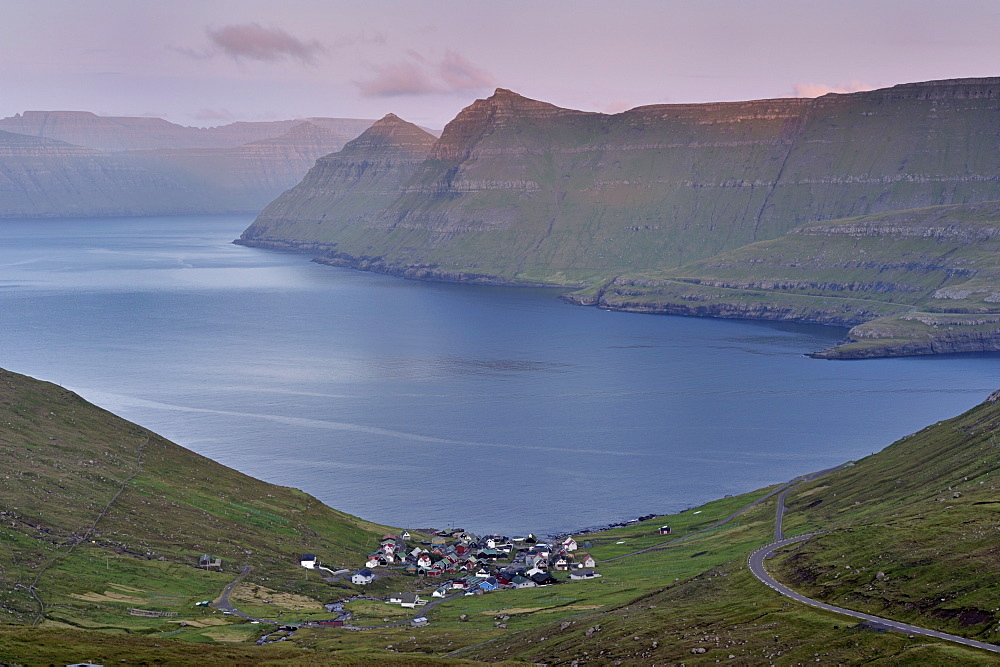 Funningur in Funningsfjordur, with view on Eysturoy and Kalsoy (in the distance) steep hills, at sunset. Eysturoy, Faroe Islands (Faroes), Denmark, Europe