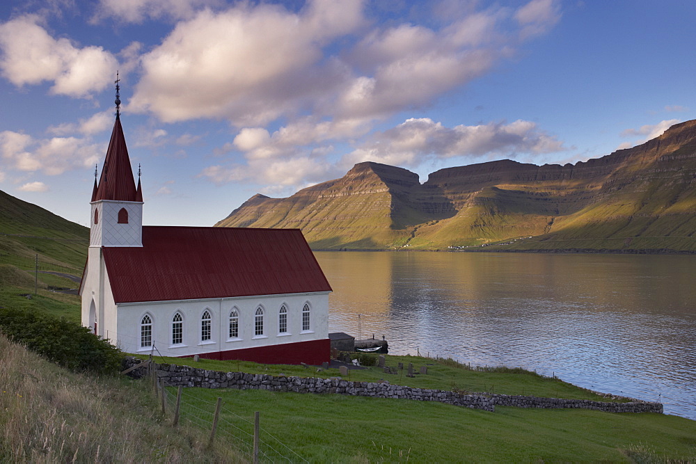 Church built in 1920 at Husar, Kalsoyarfjordur and Kunoy hills in the distance, Kalsoy, Nordoyar, Faroe Islands (Faroes), Denmark, Europe