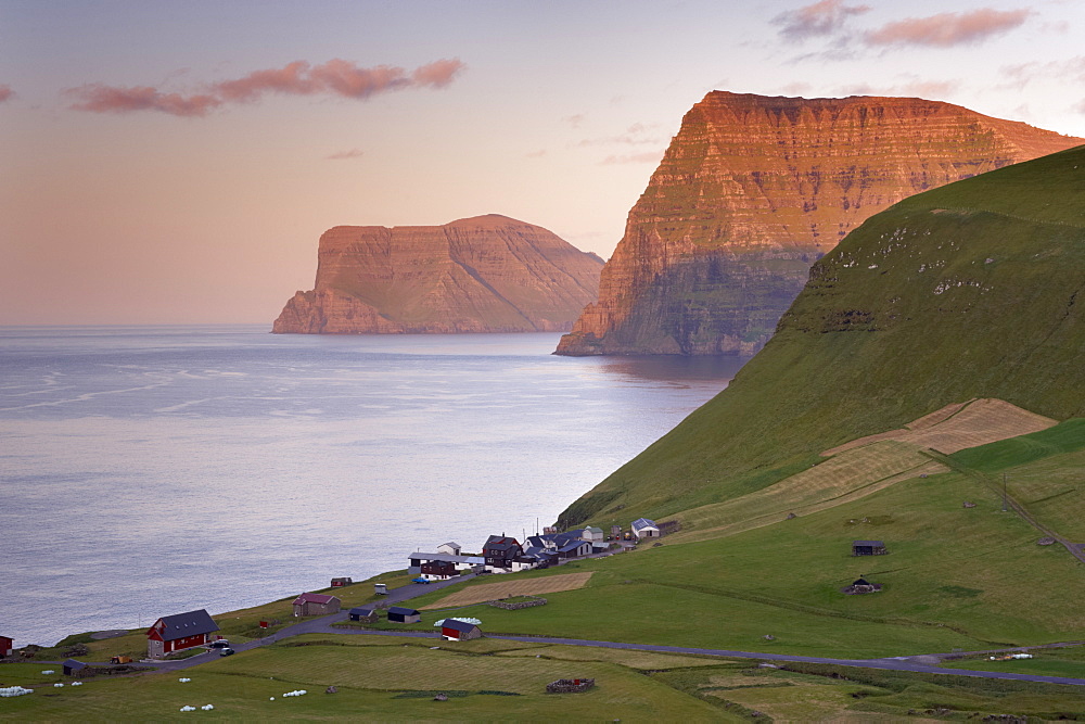 Village of Trollanes on Kalsoy, with view of Kunoy and Vidoy high cliffs of Kunoyarnakkur and Villingadalsfjall,  across Kalsoyarfjordur, Kalsoy Island, Nordoyar, Faroe Islands (Faroes), Denmark, Europe