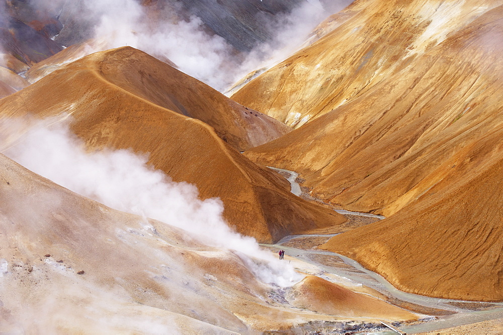 Hikers exploring the very active hot spring area at Kerlingarfjoll, where Kerlingarfjoll Mountains in the interior are a massif of rhyolitic domes rising to 1477m, Iceland, Polar Regions