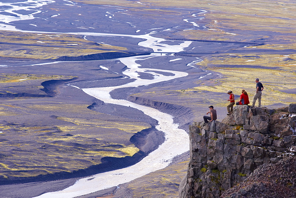 Hikers taking a rest above the Skaftafellsjokull glacier, Skaftafellsa glacial river in the background, in Skaftafell National Park, south-east Iceland (Austurland), Iceland, Polar Regions