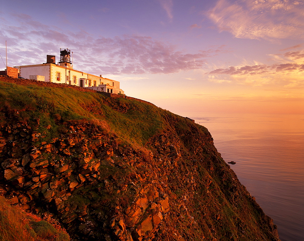 Sunset over Sumburgh Head lighthouse, built by Robert Stevenson in 1821 and now an RSPB office, Shetland Islands, Scotland, United Kingdom, Europe