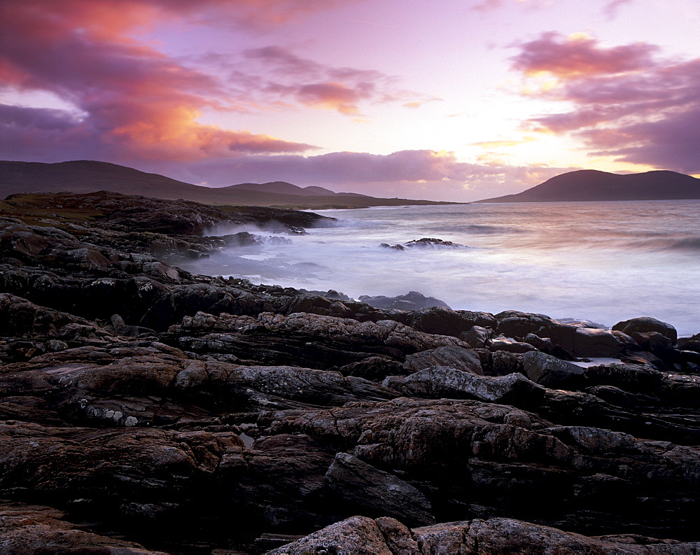 Sunset over the Sound of Taransay, Chaipaval Hill in the distance, South Harris, Harris, Outer Hebrides, Scotland, United Kingdom, Europe