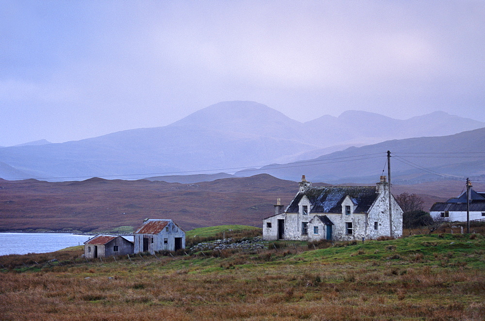 House near Achmore (Acha Mor). North Harris hills in the distance, Isle of Lewis, Outer Hebrides, Scotland, United Kingdom, Europe