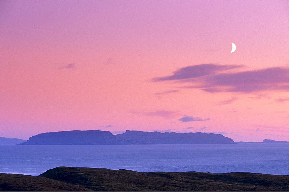 Sunset and half moon over Eigg island, from near Elgol, Isle of Skye, Inner Hebrides, Scotland, United Kingdom, Europe