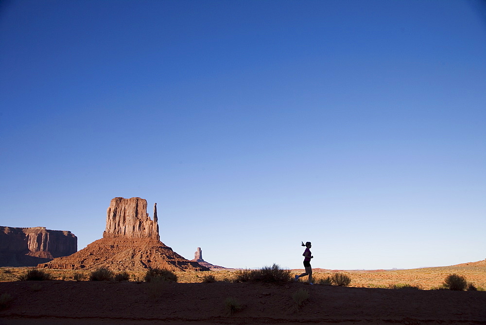 Woman jogging, Monument Valley Navajo Tribal Park, Utah Arizona border, United States of America, North America